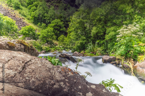 Dashbashi canyon on a summer day. The river from the waterfall, the water is blurred "in milk", Georgia