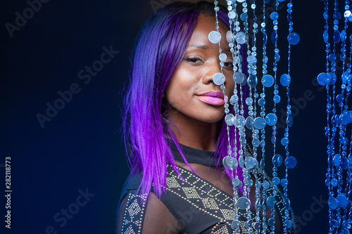 Dark Skinned Model With Purple Hair An African Girl Stands Next To A Decorative Curtain Model