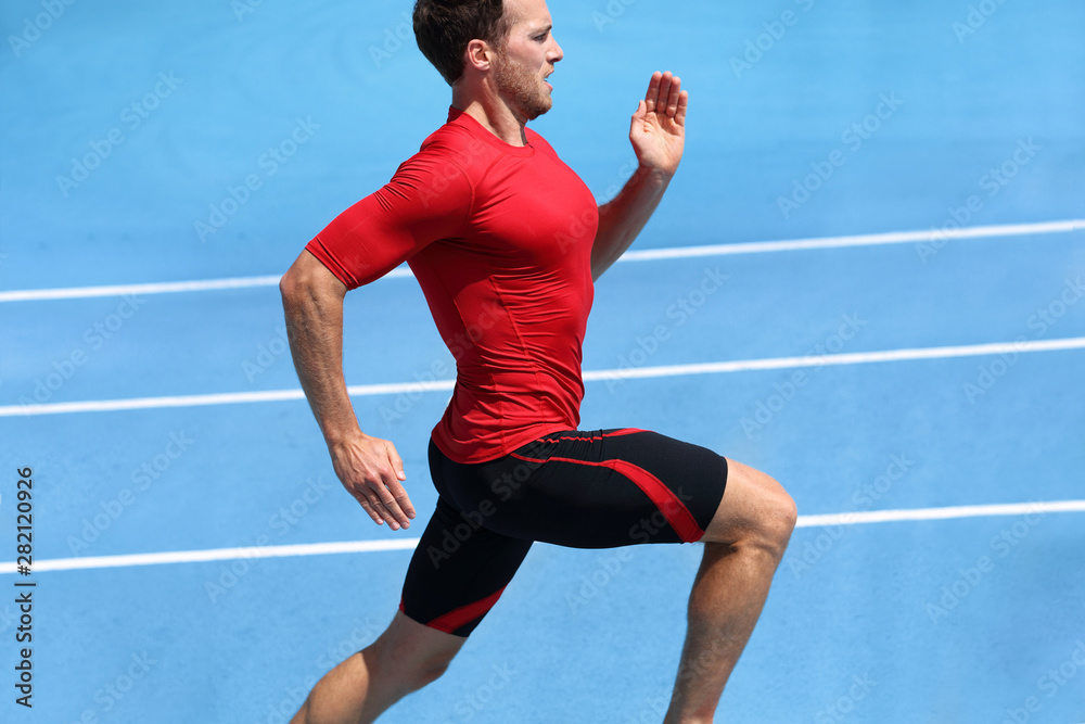 Fitness exercise sprint runner man sprinting on running track race.