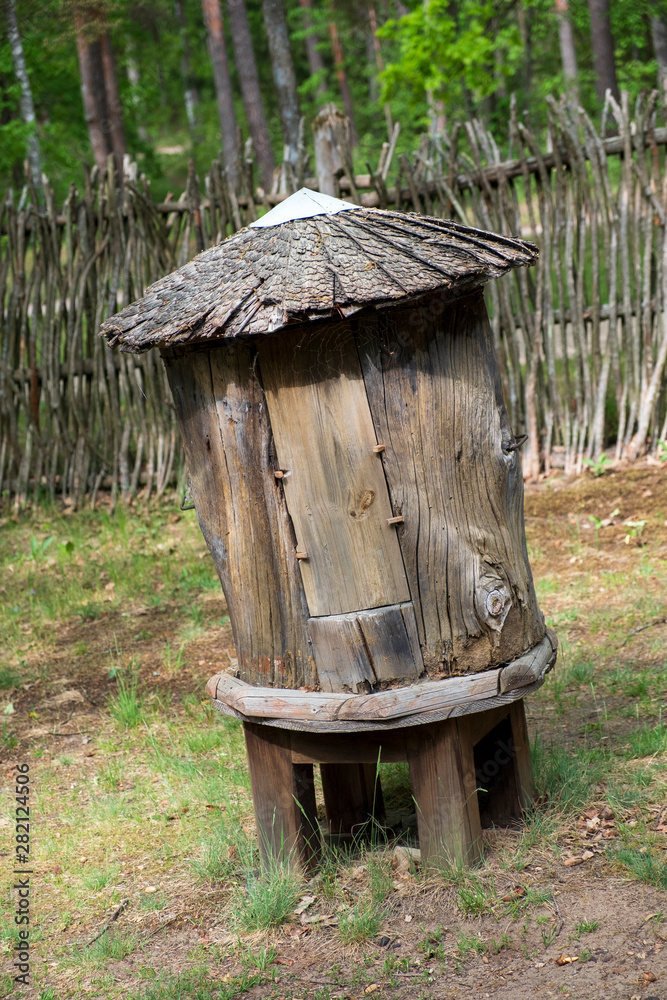 Fototapeta premium antique round wooden beehive for bees