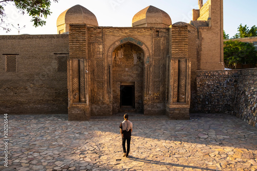 The museum of carpet weaving, former Magoki-Attari mosque, Bukhara, Uzbekistan. Man going to the entrance photo