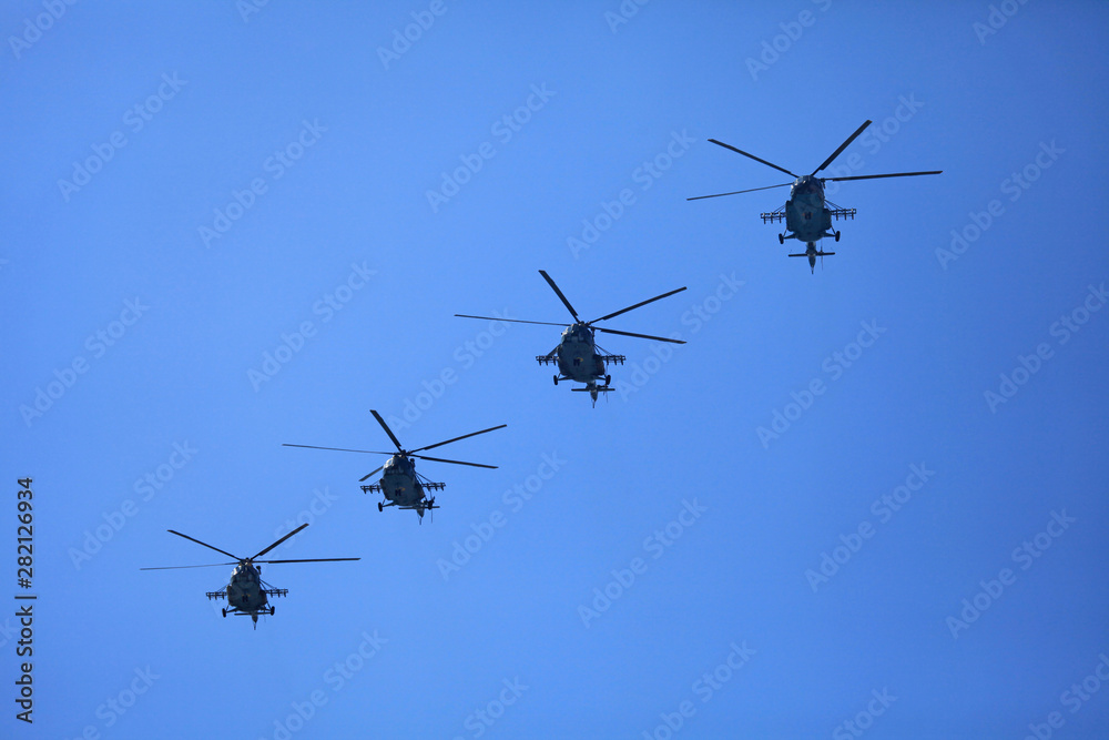 Obraz premium Kyiv, Ukraine - August 24, 2018: Helicopters (military multipurpose Mi-8) in the sky during the military technique parade in Kiev. Independence day celebration. Military equipment of the armed forces 