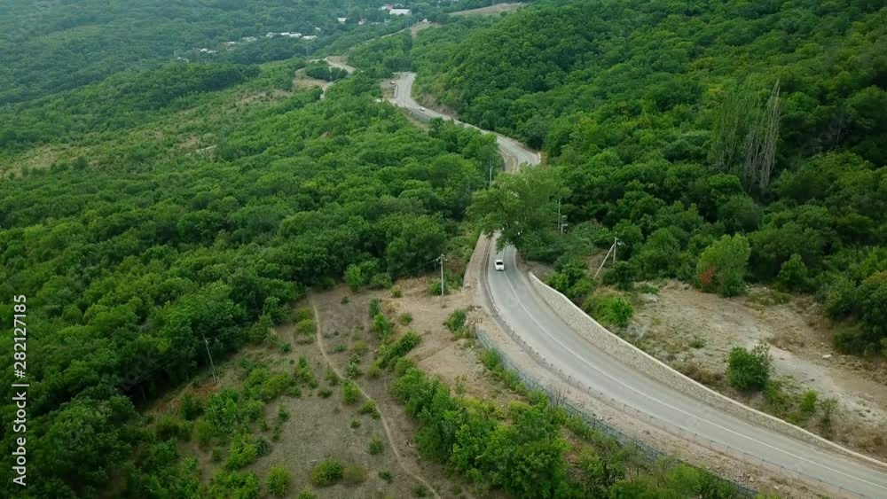 Drones Eye View - winding road from the high mountain pass to Crimea. Great road trip. Drones Eye View - winding road from the high mountain pass to Crimea. Great road trip.