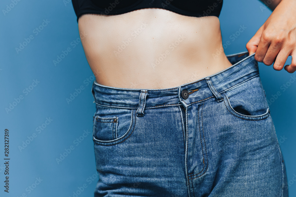skinny woman body with Loose pants jeans, Light weight body with loose  clothes, slender and Healthy body low fat concept Stock Photo | Adobe Stock