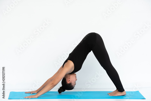 Yoga Asian woman doing exercise on white background.