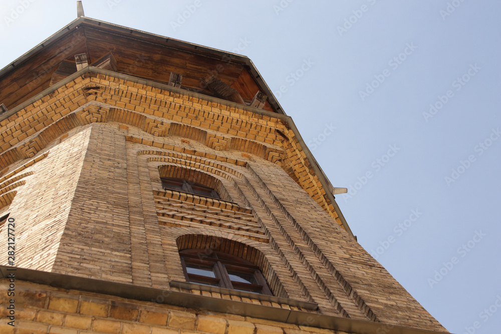 Old water tower building yellow brick wall European architecture