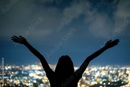 silhouette Woman portrait in city night light bokeh background , Chiang mai ,Thailand