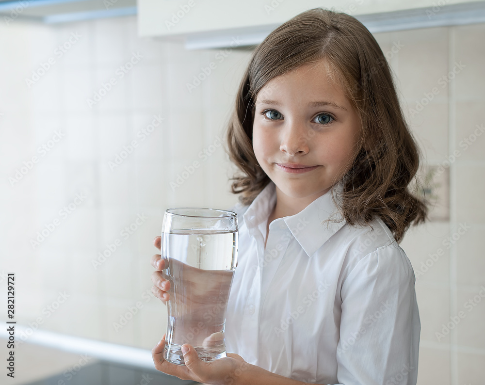 Little child is drinking clean water at home, close up. Caucasian cute girl with long hair is holding a water glass in her hands. Taking care of own health. Concept of healthy lifestyle, good habit Little child is drinking clean water at home, close up. Caucasian cute girl with long hair is holding a water glass in her hands. Taking care of own health. Concept of healthy lifestyle, good habit
