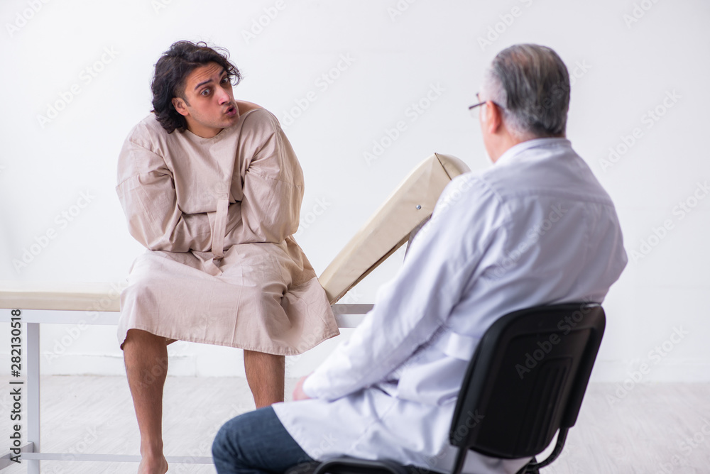 Aged male doctor psychiatrist examining young patient Aged male doctor psychiatrist examining young patient