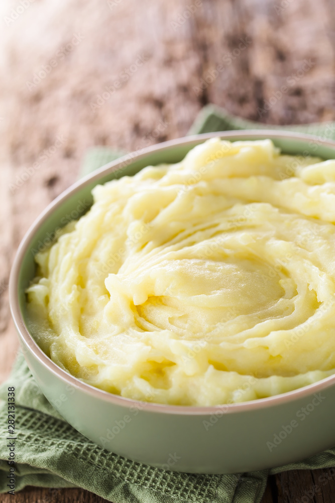 Fresh homemade creamy mashed potato in bowl (Selective Focus, Focus in the middle of the potato puree) Fresh homemade creamy mashed potato in bowl (Selective Focus, Focus in the middle of the potato puree)