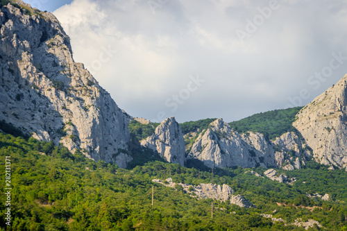 Russian mountains. Crimea. Summer mountains background. Forest and mountains in the sun on the background of a cloudy sky above the peninsula of Crimea. Sunny, bright, saturated raster photo © alenka2194