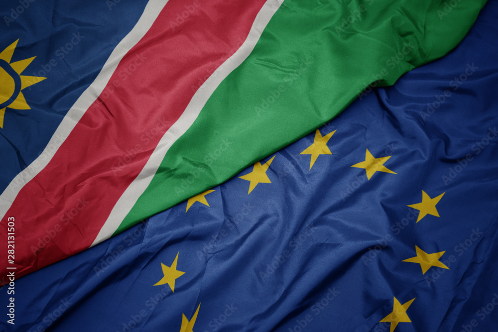 Fototapeta premium waving colorful flag of european union and flag of namibia.