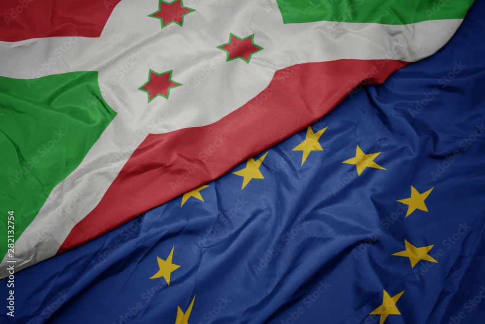 waving colorful flag of european union and flag of burundi . waving colorful flag of european union and flag of burundi .