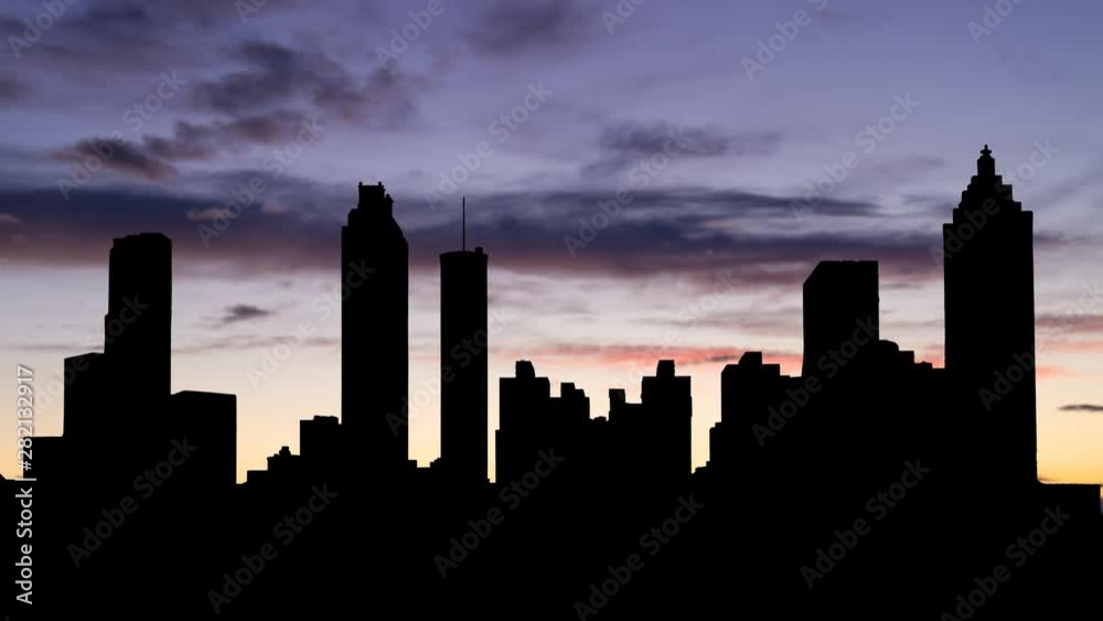 Atlanta: Time Lapse of City at Dusk with Dark Skyline of Downtown and Colorful Clouds in Background, Florida, USA Atlanta: Time Lapse of City at Dusk with Dark Skyline of Downtown and Colorful Clouds in Background, Florida, USA
