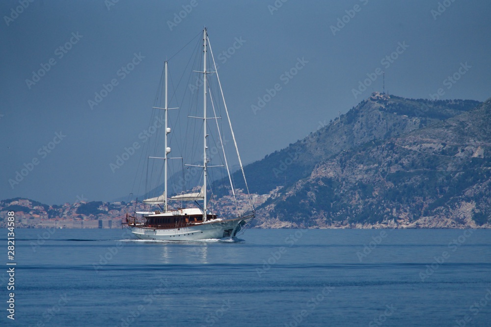 Sailing boat in front of the coast