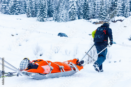 Ski patrol team rescue woman skier with broken leg