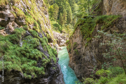 Turquoise or emerald colored water of the canyon Tiefenbachklamm in Tirol, Austria