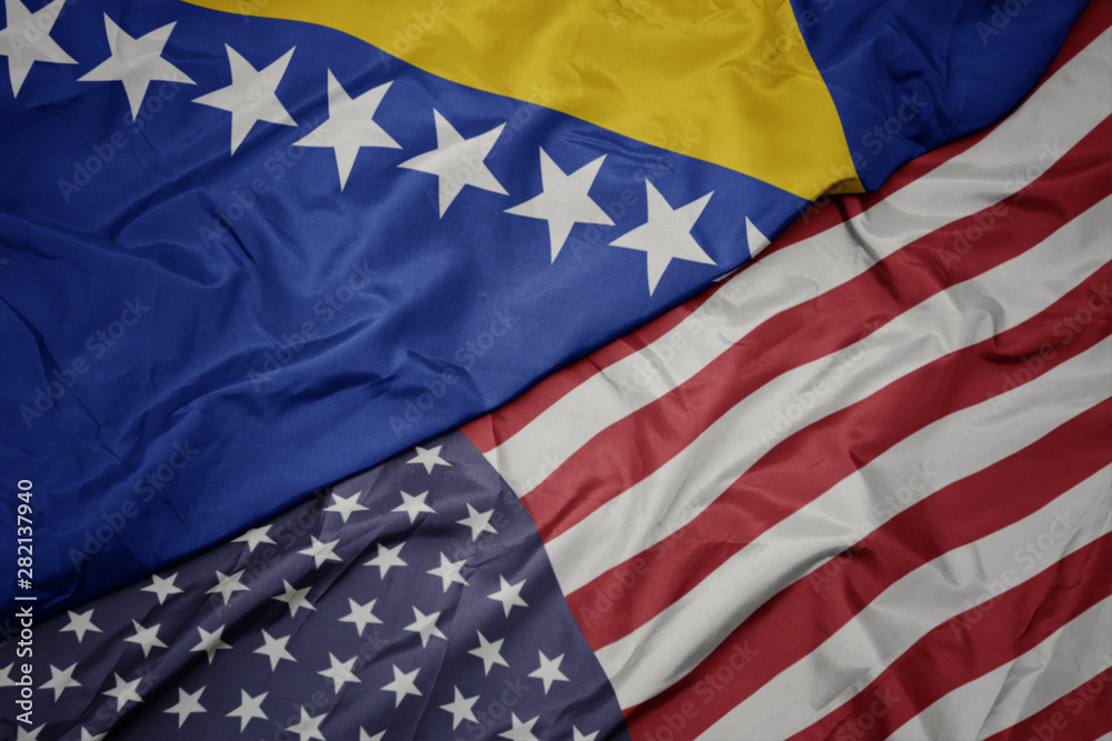 Obraz premium waving colorful flag of united states of america and national flag of bosnia and herzegovina.