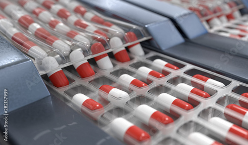 Red and white capsules in pharmaceutical production line. 3D ren photo