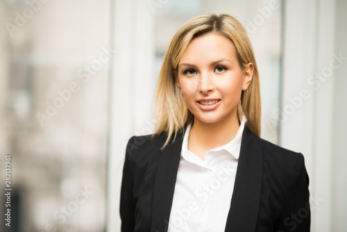 Smiling businesswoman in front of a window