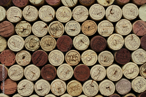 Cork wine bottle tops with numbers of years arranged close to each other. Closeup