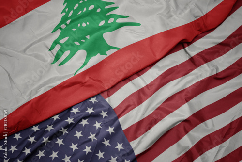 waving colorful flag of united states of america and national flag of lebanon. photo