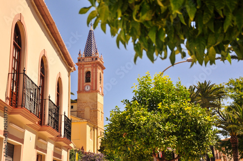 Iglesia Santa Maria de Reposo church bell tower in Campillos Town, Andalucía. Famous old town square (Plaza España). photo