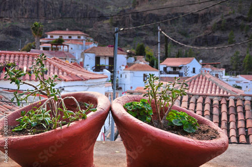 Two large ceramic flower pots with town of Fataga in the background. South of Gran Canaria, Canary Islands