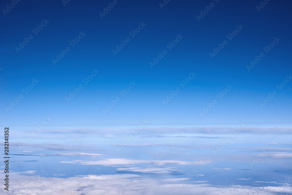 Blue sky above the clouds from airplane window Blue sky above the clouds from airplane window