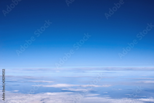 Blue sky above the clouds from airplane window