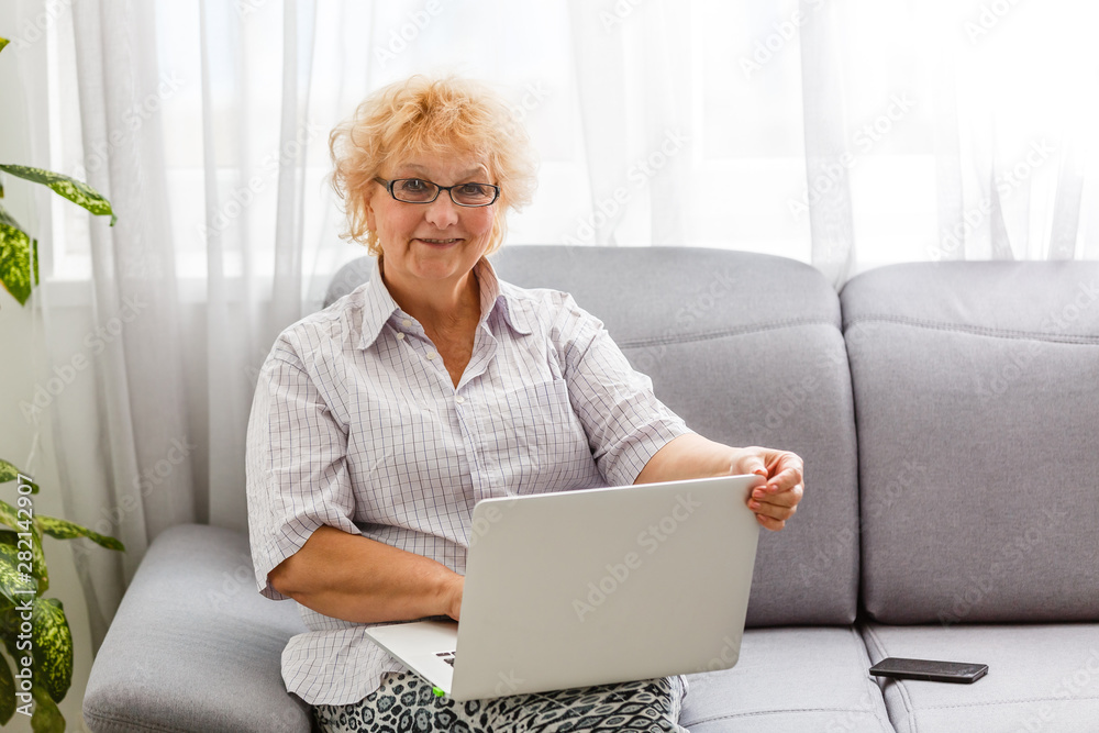 Happy mature middle aged elderly business woman winner excited by reading good news looking at laptop, glad senior older lady watching celebrating online bid bet win or great result victory concept Happy mature middle aged elderly business woman winner excited by reading good news looking at laptop, glad senior older lady watching celebrating online bid bet win or great result victory concept