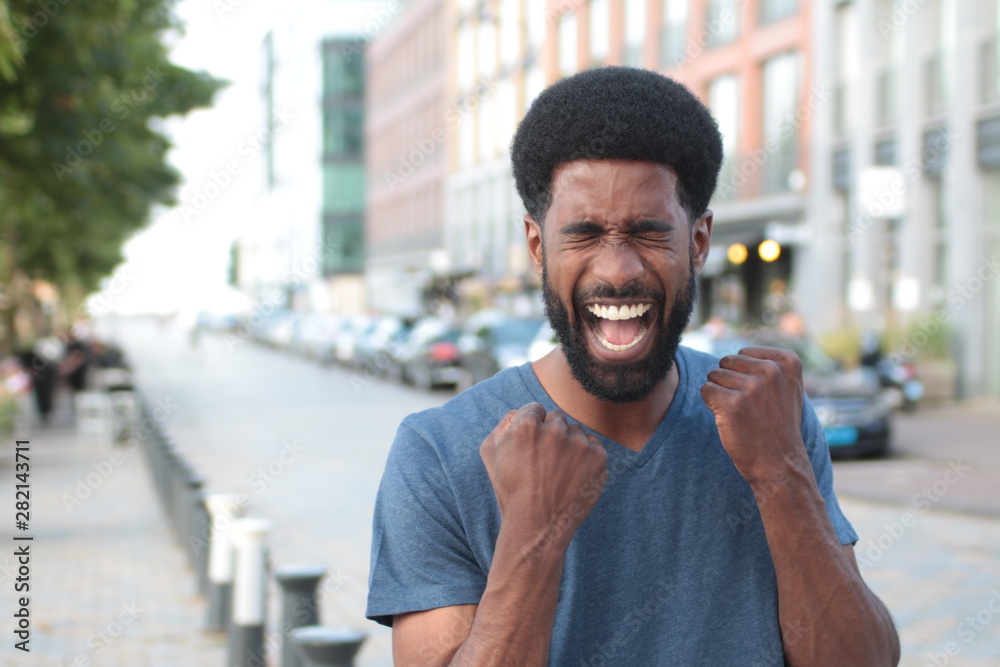 Beautiful happy man outside in the park