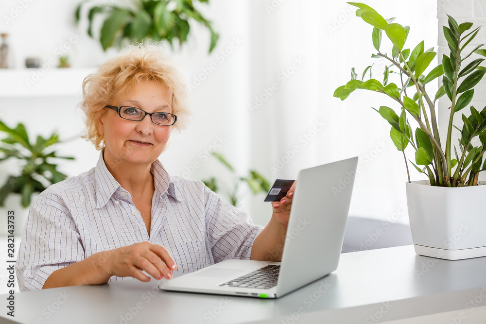 an elderly woman shopping online an elderly woman shopping online