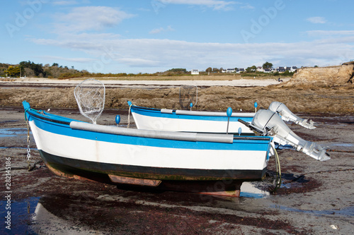 Boats moored in the harbor of Primelin at low tide