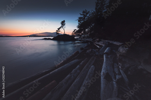 Stunning lighthouse sunsets on a rocky beach with mountains surrounding.  Bowen Island BC Canada.  Close to downtown Vancouver.