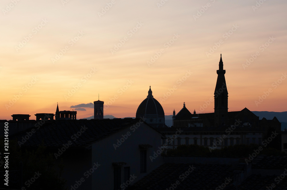 Sihouettes of landmarks from hill near at sunset in Florence, Italy. Santa Maria del Fiore in the evening