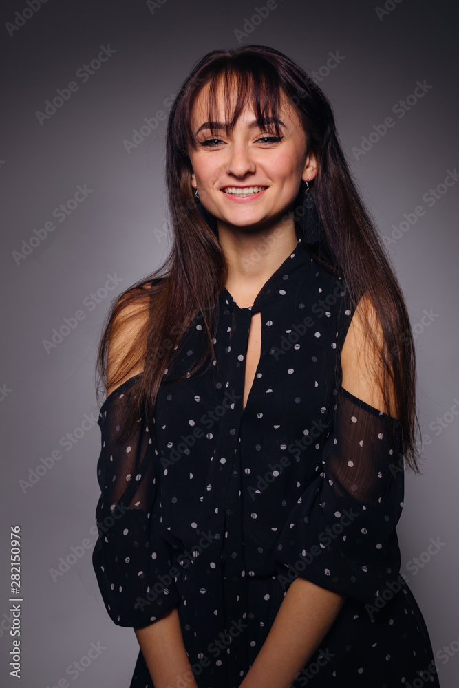 Studio portrait of young elegant woman with a beautiful smile an Studio portrait of young elegant woman with a beautiful smile an