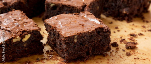Bild auf Leinwand Home-baked chocolate brownies on a baking sheet, side view