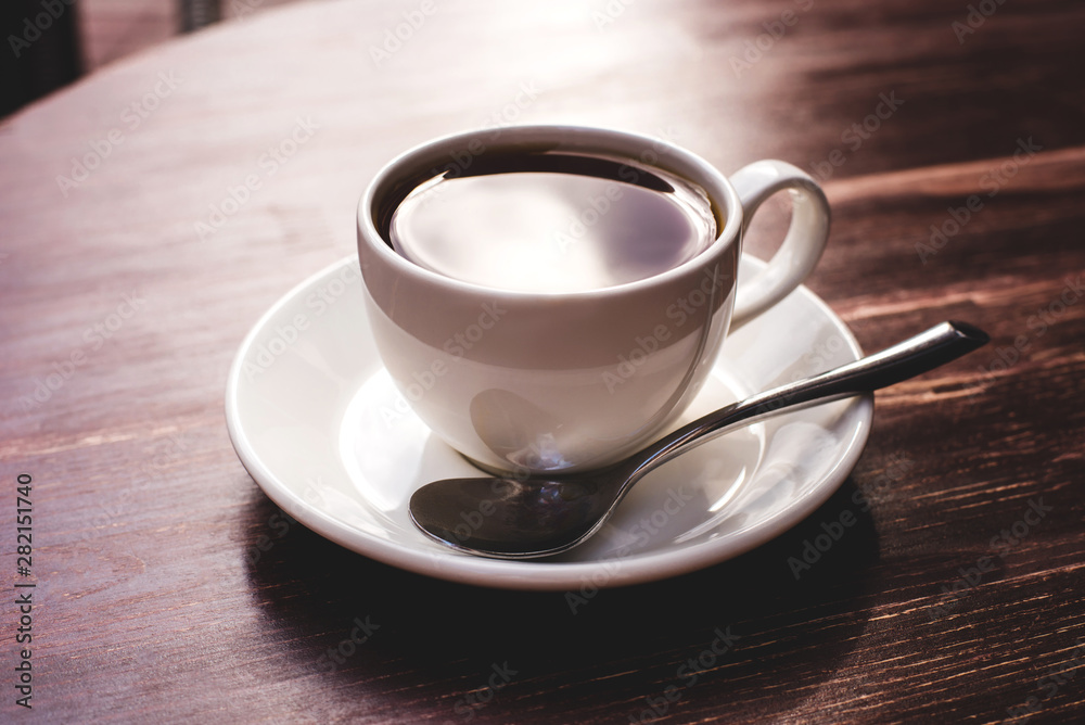 One cup of black tea on a wooden table. Copy space for your text. One cup of black tea on a wooden table. Copy space for your text.