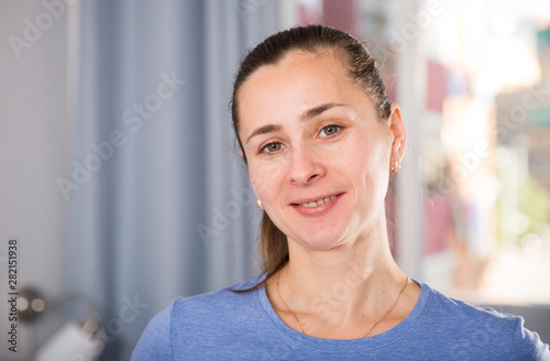Portrait of cheerful female who is posing at home