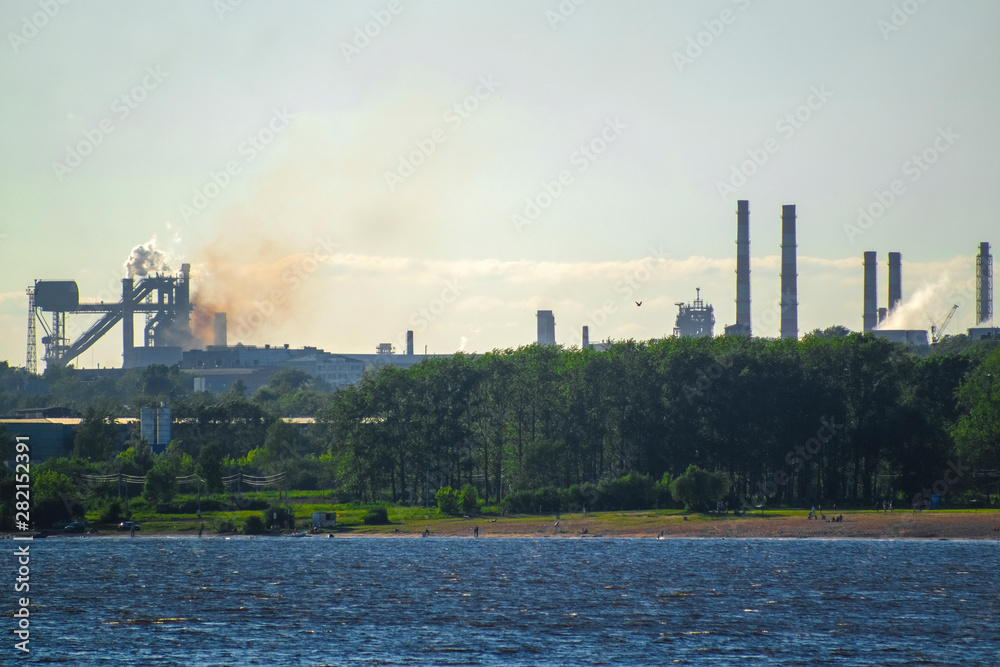 Obraz premium Cherepovets, Russia - June, 9, 2019: Image of a metallurgical factory in the city of Cherepovets, Russia, located on the banks of the river