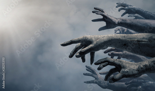 Zombie hands rising in dark Halloween night. photo