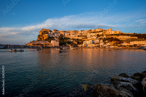 Setting sun lit city over the sea