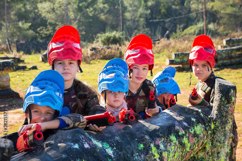 Kids paintball players aiming outdoors