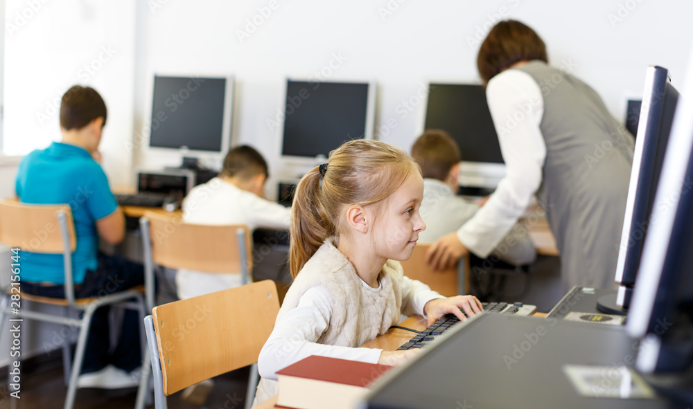 Preteen girl studying in computer class