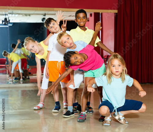 Fototapeta Naklejka Na Ścianę i Meble -  Happy emotional children posing at modern dance class