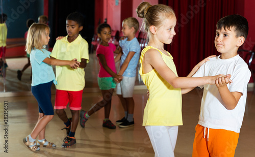 Children trying partner dance in class