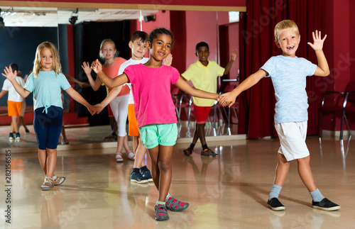 Joyful children trying dancing partner dance