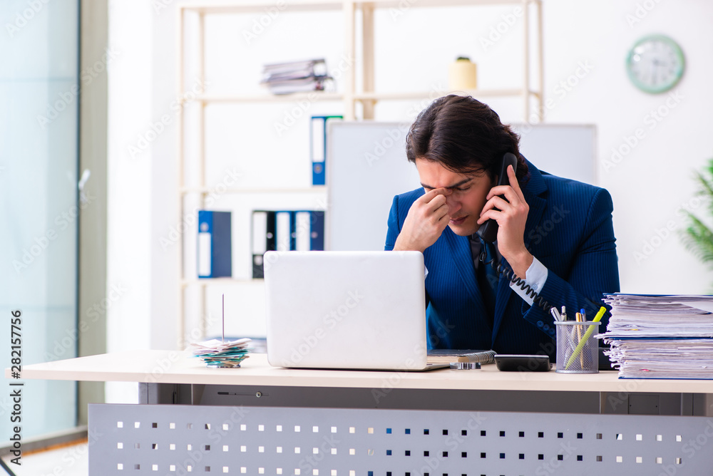 Young businessman sitting and working in the office Young businessman sitting and working in the office