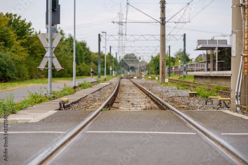 Close up view of empty railway track near platform train station in countryside area in Germany.